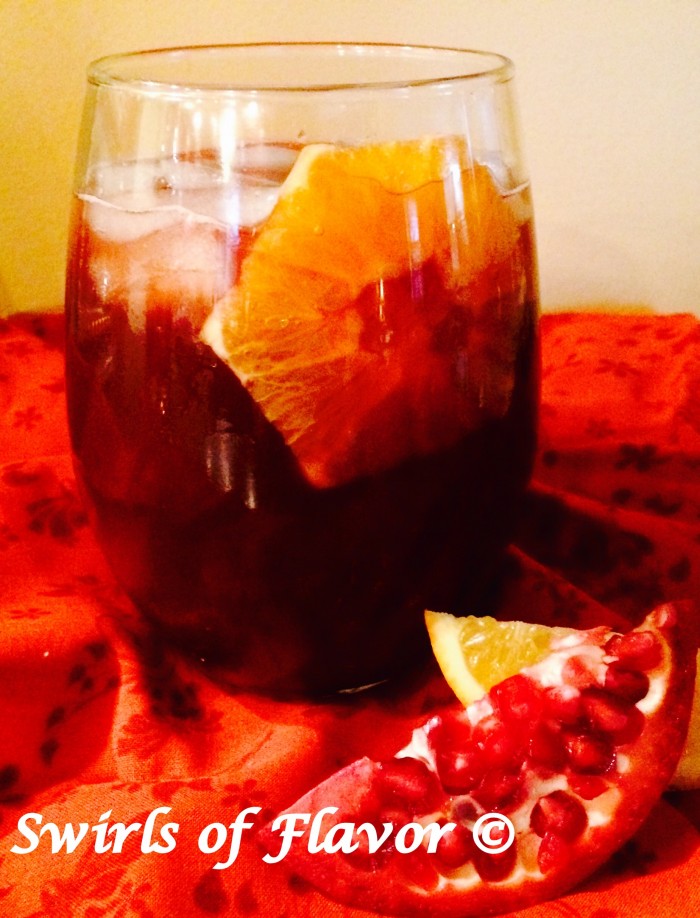 Pomegranate Bourbon Punch in stemless wine glass