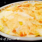 Slices of potatoes are gently boiled in a shallot cream mixture and then layered with cheese and baked to a cheesy, creamy perfection in our Golden Potatoes Au Gratin, recipe.