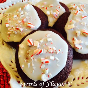 The ever popular red velvet cupcake has just become a cookie! Topped with a peppermint glaze and crushed candy canes and they become Peppermint Crunch Red Velvet Cookies!