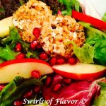 Pomegranate Apple Mixed Greens With Walnut-Crusted Goat Cheese elevates salad to a new level with homemade pomegranate vinaigrette and nutty cheese rounds! This homemade vinaigrette and easy nut crusted cheese rounds is the perfect holiday recipe! #salad #mixedgreens #homemadevinaigrette #pomegranatevinaigrette #hlidayrecipe #Thanksgiving #Christmas #tossedsalad #swirlsofflavor