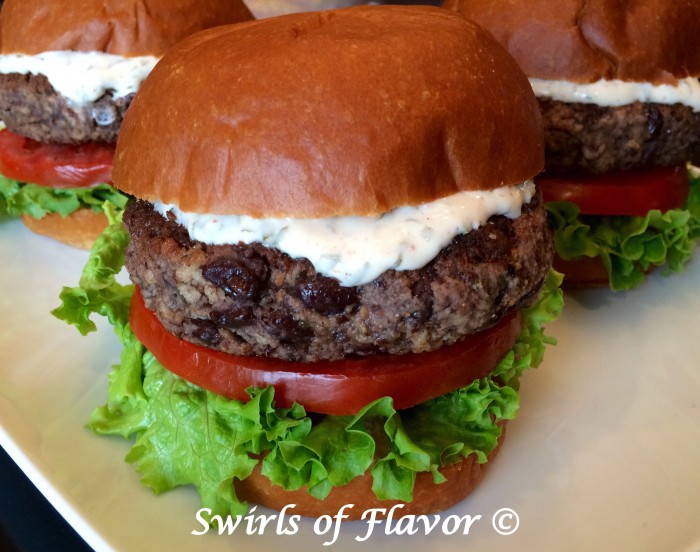 Black bean burgers perfectly seasoned with chili powder and cumin are topped with a creamy aioli bursting with the fresh flavors of cilantro and lime.Meatless Monday never tasted so good! burgers | black beans | black bean burgers | meatless | vegetarian