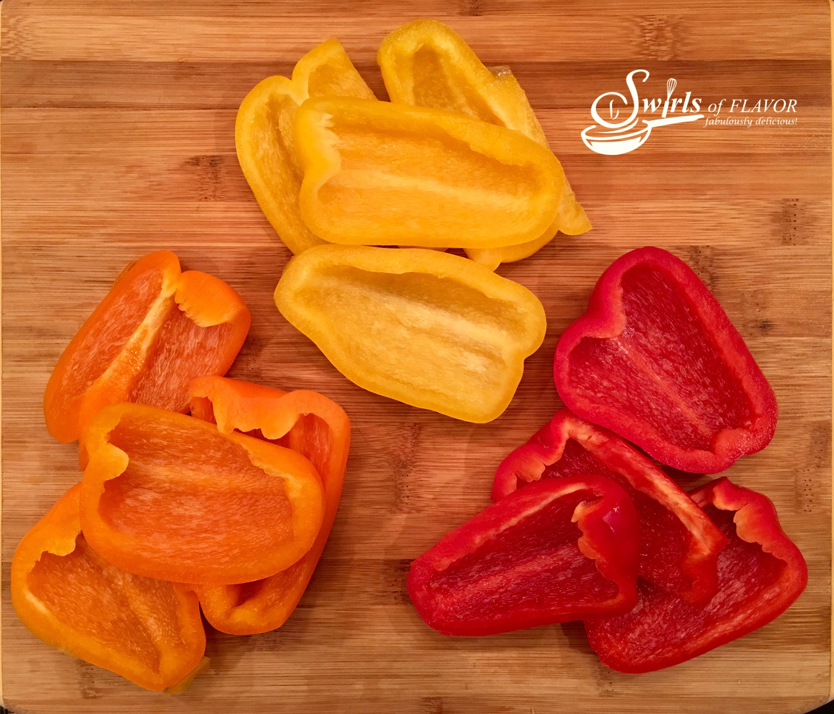 red bell peppers, orange bell peppers and yellow bell peppers, cut up