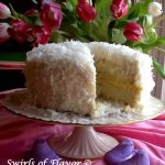 Coconut Lemon Cake is a homemade coconut cake topped with coconut buttercream and flaked coconut. A tangy lemon filling makes every bite heaven!