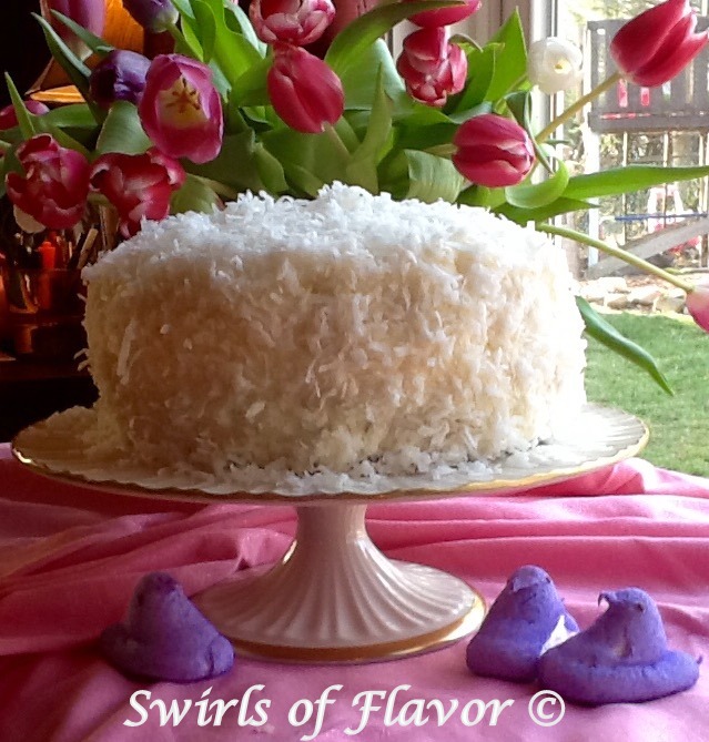 coconut cake with shredded coconut on cake stand