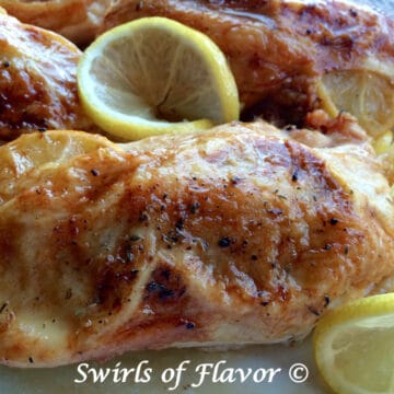 Oven Roasted Chicken With Lemon and Thyme and frresh lemon slices lemon slices