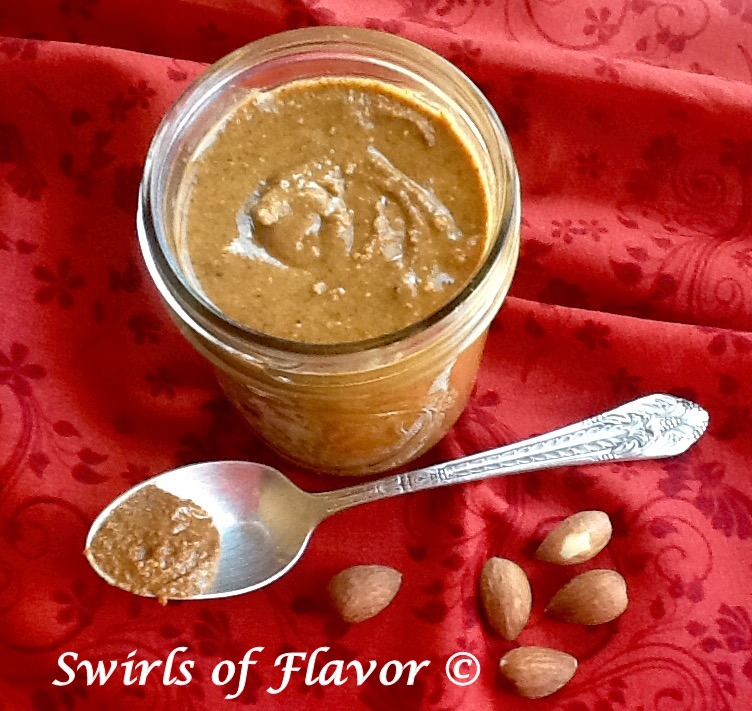 homemade almond butter with cinnamon in a jar with spoon