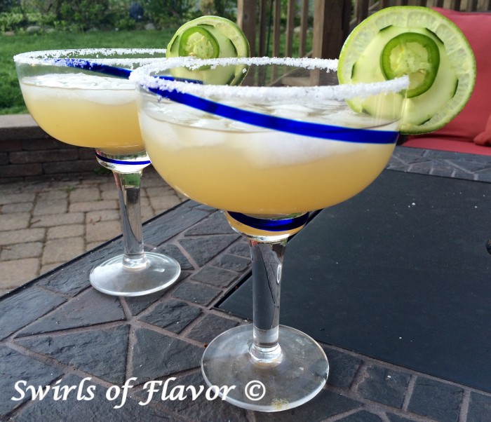 Jalapeno and cucumber are infused in a margarita mixture lending just the right amount of heat from the jalapeno, that builds at the end of each sip, balanced with the cool crisp flavor of the cucumber in these Jalapeno Cucumber Margaritas! drinks | cocktails | easy recipe | jalapeno | cucumber | Margarita | summer drinks | #swirlsofflavor