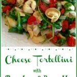 Cheese Tortellini with arugula, tomatoes and pancetta on a white platter