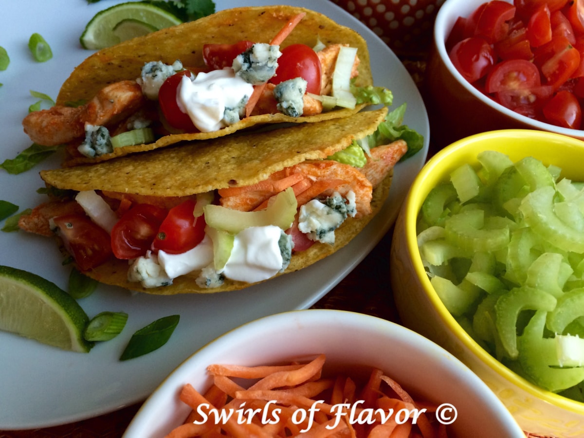 buffalo chicken tacos with toppings in bowls