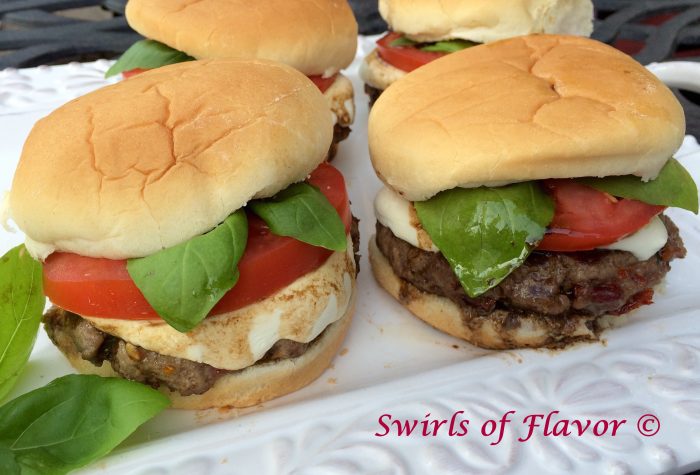 Caprese Burgers are seasoned with bits of sundried tomatoes and topped with melted fresh mozzarella, sliced tomato, fresh basil leaves and a balsamic drizzle! caprese | burgers | grilling | ground beef | tomsto | mozzarella | basil | balsamic vinegar