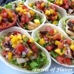 It's Taco Tuesday! Season and grill your favorite fish, top with a fresh Mango Pico De Gallo and your Fish Tacos With Mango Pico De Gallo will be bursting with tropical flavors! #fish #fishtacos #mango #picodegallo #homemade #tacotuesday #easyrecipe #dinner #swirlsofflavor