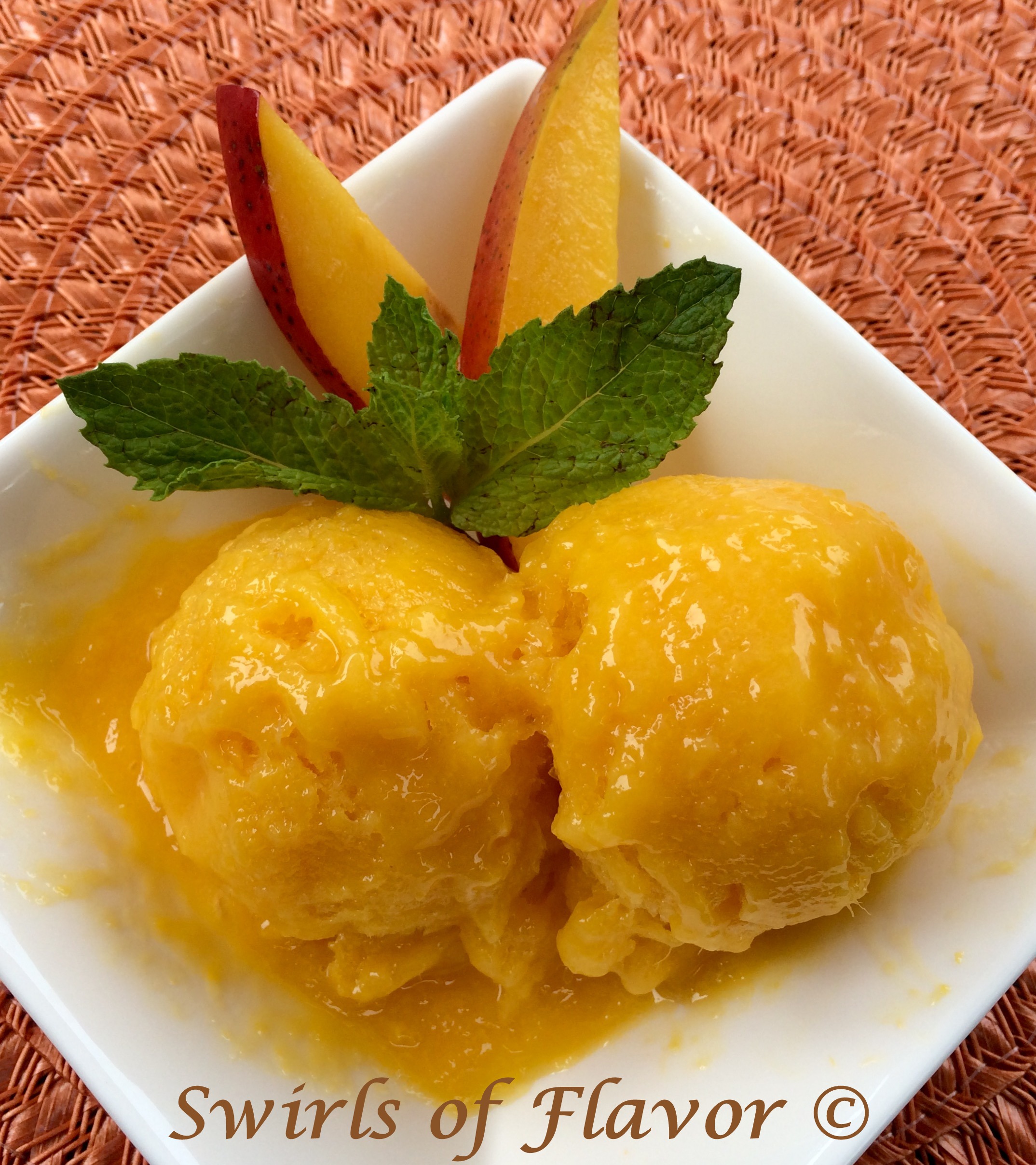 Mango Sorbet recipe in white dish with fresh mnt and mango slices