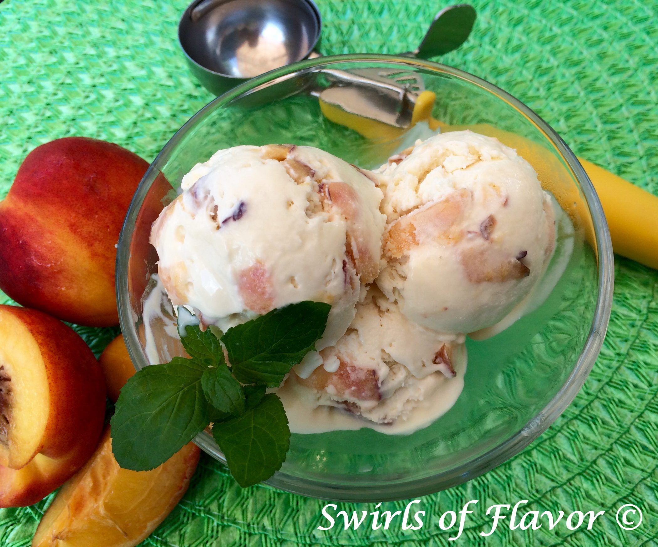 homemade peach ice cream in bowl with fresh mint