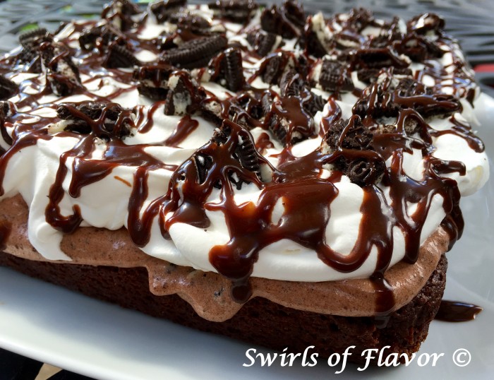 Oreo Pudding Brownie Poke Cake is filled with chocolate pudding and topped with a layer of cookie pudding, whipped topping, cookie pieces and fudge sauce! easy recipe | dessert | chocolate | oreo cookies | Father's Day | #swirlsofflavor
