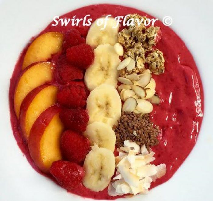 raspberry smoothie bowl with nectarie, banana and toppings