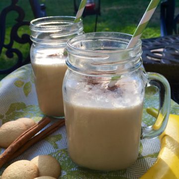 two mason jars with handles filled with banana smoothie recipe
