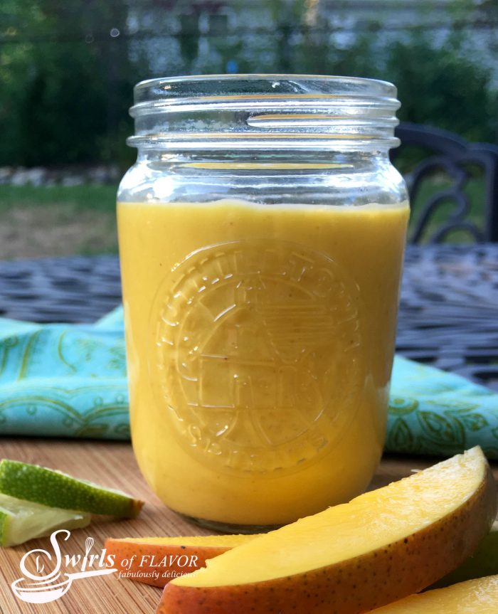 Chipotle Mango Vinaigrette is a sweet yet tangy creamy homemade salad dressing with just a hint of spice. Juicy sweet mango combines with key lime juice and honey for a fresh summery flavor combination that will dance on your taste buds. #easyrecipe #homemade #homemadesaladdressing #vinaigrette #mango #summerrecipe #creamysaladdressing #entertaining #swirlsofflavor