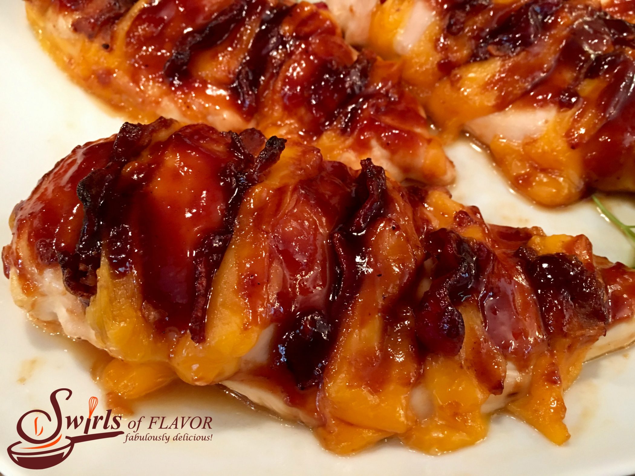 Cheddar Bacon Hasselback Chicken on white dish