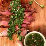 Spice-Rubbed Sirloin With Chimichurri Sauce is a flavorful and easy recipe for dinner tonight! Seasoned steak topped with a homemade chimichurri sauce is bursting with fresh vibrant flavors that will dance on your palate! It's garlicky, herby, spicy and tangy all at the same time! #steak #beef #sirloin #skirtsteak #flanksteak #dinner #easyrecipe #homemadechimichurrisauce #chimichurrisauce #herbsauce #swirlsofflavor