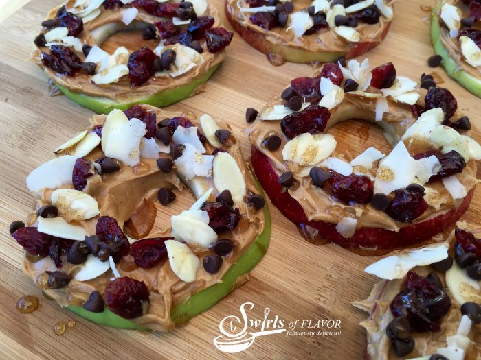 Peanut Butter Honey Apple Slices are an easy recipe for an after school snack. Apple slices are topped with peanut butter, cranberries, almonds and coconut and a cinnamon honey drizzle! #apple #apples #appleslices #funforkids #applesnacks #peanutbutter #coconut #honey #healthy #dessert #snack #swirlsofflavor