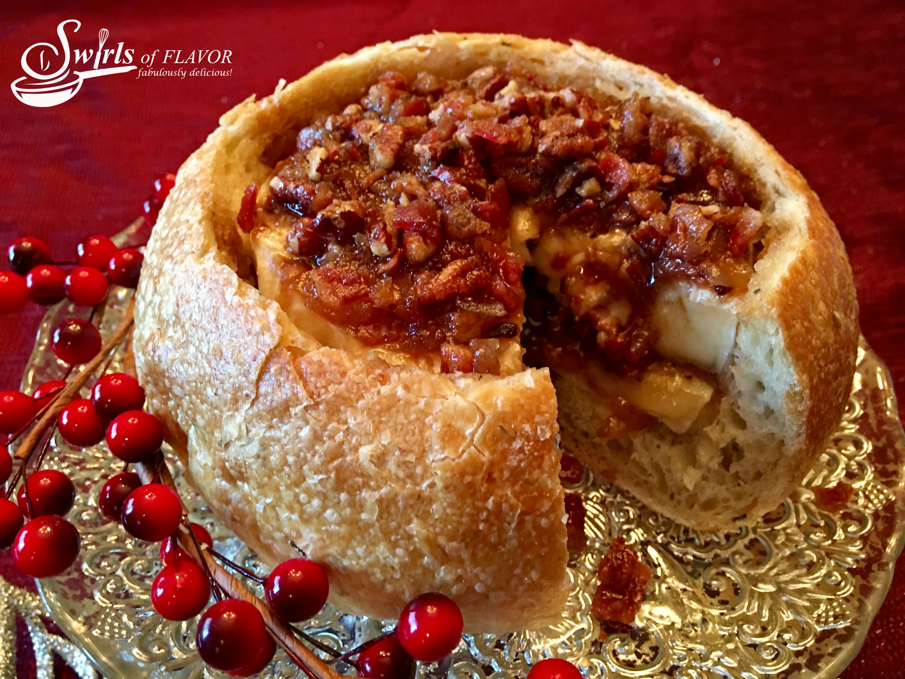 Brandied Bacon Baked Brie is a sweet and savory mixture of bacon, pecans, brown sugar, maple syrup and Brandy combined with a layer of bacon jam on a Brie cheese wheel that's nestled in a crusty bread bowl and baked into divine creaminess!