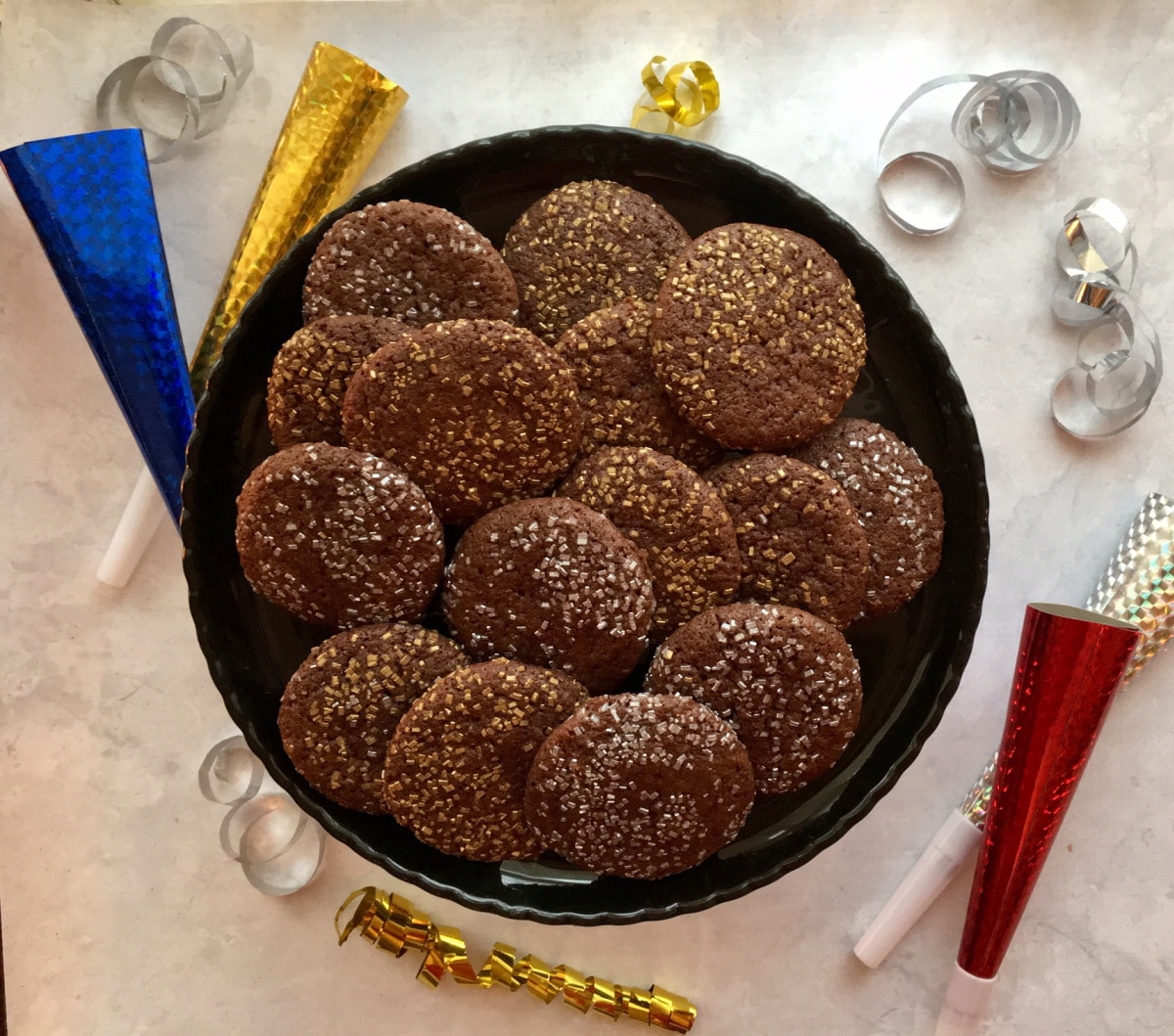 silver and gold chocolate cookies on a black dish