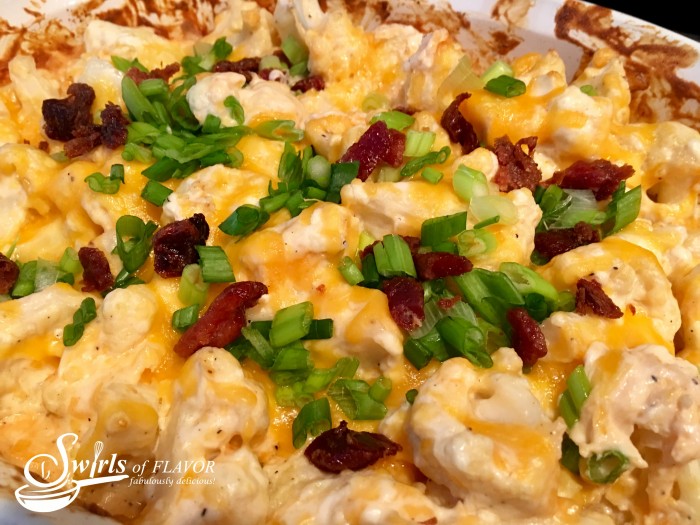 Oven-roasted cauliflower is cooked to perfection with cheesy goodness that melts into all the nooks and crannies. Studded with bits of crispy turkey bacon and scallions, Loaded Baked Cauliflower Casserole really is the healthy alternative to the classic loaded baked potato that you've been looking for! #Cauliflower #lowfat #lowcalorie #lowcarb #cheese #sidedish #easyrecipe #vegetable #casserole #swirlsofflavor
