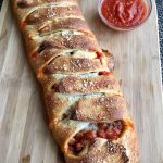 Meat Lovers’ Pizza Bread is brimming with seasoned saucy ground beef, spicy pepperoni and three cheeses. A hearty appetizer, our Pizza Bread is a crowd-pleasing easy recipe to make. A perfect pizza recipe for game day, entertaining and the holidays! #pizza #appetizer #stuffedpizza #meatlovers #easyrecipe #crowdpleaser #pizzabrread #cheese #swirlsofflavor