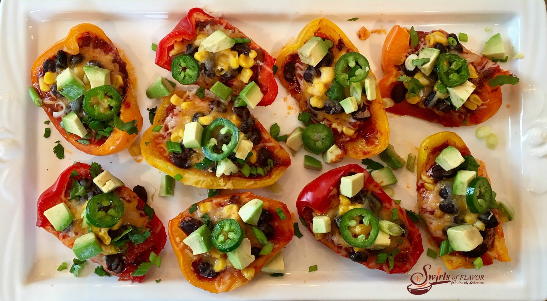 Spicy Nacho Stuffed Peppers are seasoned withÂ taco seasoningÂ and brimming with salsa, black beans, corn, avocado, jalapeno and cheesyÂ goodness!Â #nachos #easyrecipe #appetizer #nachosrecipe #lowfat #glutenfree #cheese #stuffedpeppers #swirlsofflavor