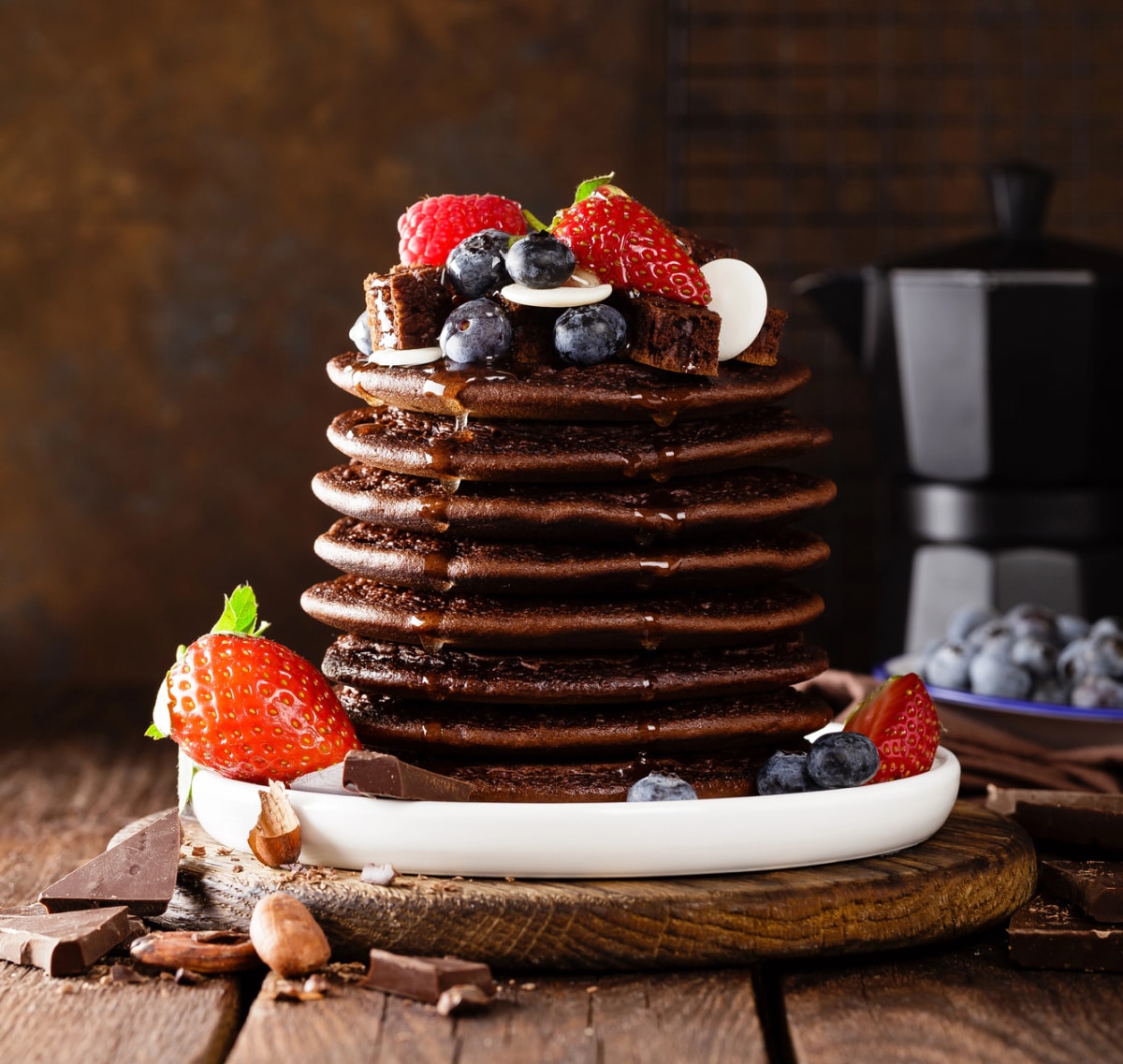 stack of chocolate pancakes with berries