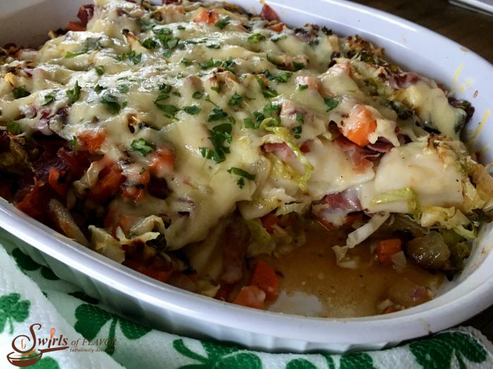 Corned Beef and Cabbage Casserole combines all the flavors of your St. Patrick's Day dinner in one dish. Cabbage, carrots and sweet onions sauteed in a Guinness reduction are layered with cheddar and potato filled pierogies, corned beef and aged Irish cheddar cheese. #cornedbeef #cabbage #cornedbeefandcabbage #casserole #dinner #irish #stpatricksday #easyrecipe #dinner #swirlsofflavor