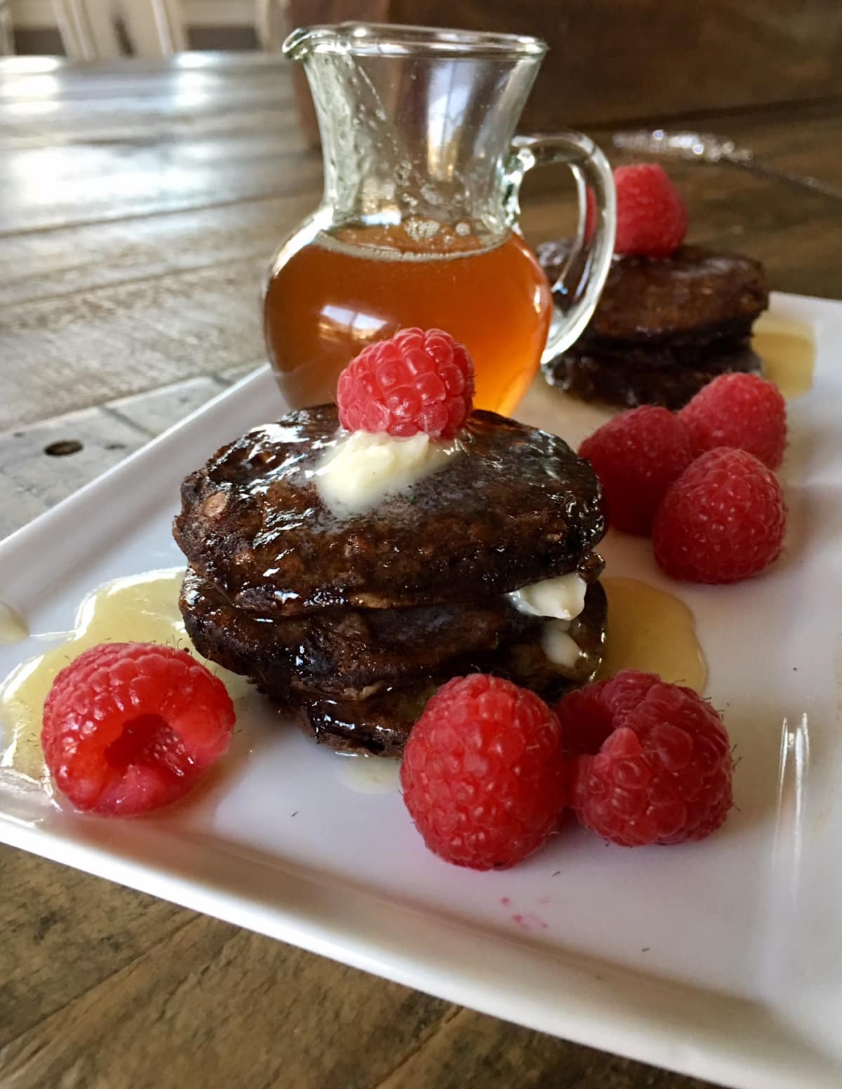 chocolate oat pancakes with syrup and butter