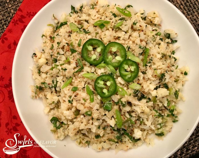 Jalapeno Lime Cauliflower Rice is a healthy cauliflower rice recipe bursting with the flavors of spicy jalapeno balanced with the freshness of chopped cilantro and lime juice! An easy recipe for a side side that can also be Whole30 with just one substitution. #cauliflower #cauliflowerrice #sidedish #vegetarian #vegetable #whole30 #easyrecipe #meatlessmonday #lowcarb #healthy #glutenfree #swirlsofflavor