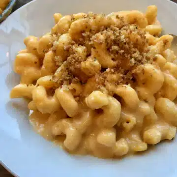 mac and cheese with breadcrumbs in a white bowl
