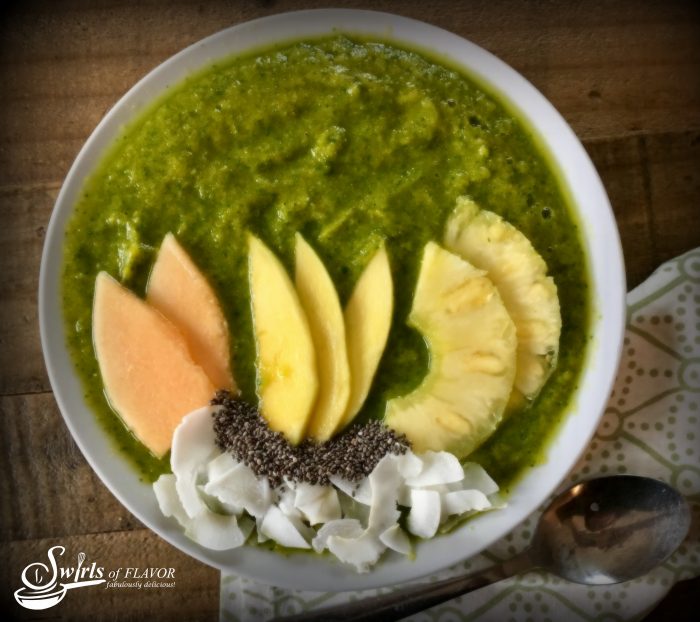 tropical smoothie bowl topped with fresh fruit and chia seeds