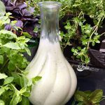 creamy green goddess salad dressing in cruet