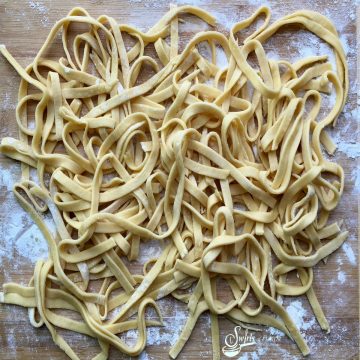 homemade pasta noodles on a wooden board