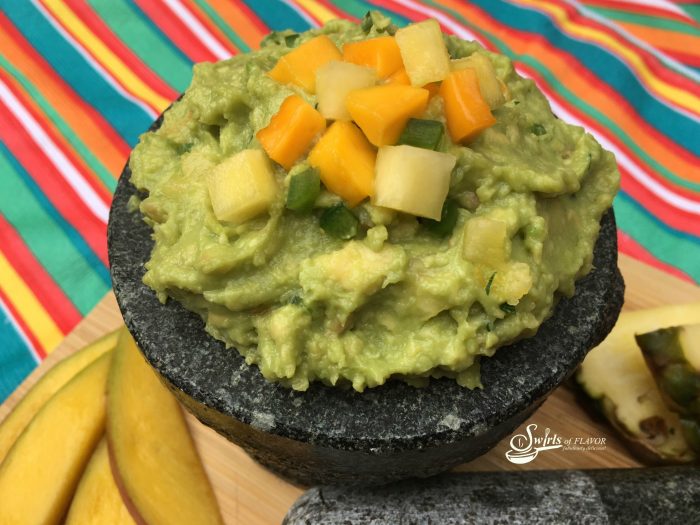 Mango and pineapple flavors will transport you to the tropics as you savor scoops of Sweet 'N Spicy Tropical Guacamole! avocado | pineapple | mango | guacamole | jalapeno }Cinco de Mayo | appetizer | snacks