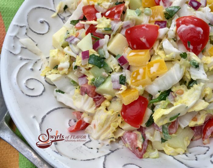 Mango Cole Slaw is a light creamy cole slaw with a tropical twist. Delicious as a side dish, on tacos, a burger or a sandwich! cole slaw | mango | mayonnaise | side dish | picnic | barbecue | potluck