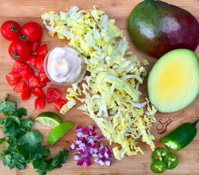 Mango Cole Slaw is a light creamy cole slaw with a tropical twist. Delicious as a side dish, on tacos, a burger or a sandwich! cole slaw | mango | mayonnaise | side dish | picnic | barbecue | potluck