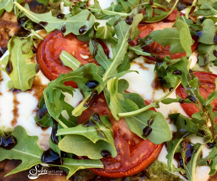Grilled Pesto Caprese Naan Pizza is bursting with the summertime flavors of fresh mozzarella, plum tomatoes and fresh pesto! Perfect for Meatless Monday! pizza | grilling | caprese | pesto | Meatless Monday | appetizer | tomatoes | mozzarella | quick and easy dinner