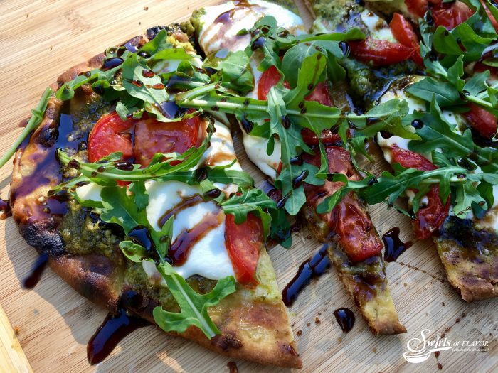 Grilled Pesto Caprese Naan Pizza is bursting with the summertime flavors of fresh mozzarella, plum tomatoes and fresh pesto! Perfect for Meatless Monday! pizza | grilling | caprese | pesto | Meatless Monday | appetizer | tomatoes | mozzarella | quick and easy dinner