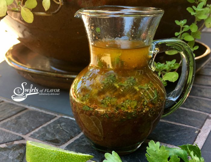 This homemade Chili Lime Vinaigrette will have your taste buds dancing as the fresh tangy flavor of lime combines with a hint of chili spice! #homemadesaladdressing #easyrecipe #vinaigrette #chilipowder #lime #cilantro #saladdressing #homemade #homemadevinaigrette #swirlsofflavor