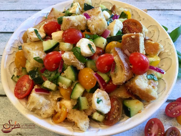 Panzanella is an easy recipe for the classic Tuscan bread salad and is bursting with heirloom tomatoes, cucumber, mozzarella and fresh basil, the flavors and colors of summer!