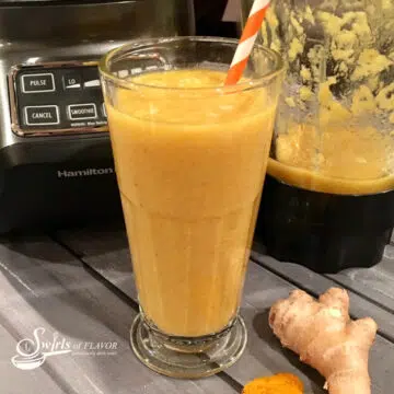 banana mango smoothie with turmeric in a tall glass