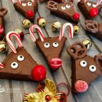 Reindeer Brownies is an easy recipe that will quickly become a holiday tradition and so much fun for kids! Fudgy homemade brownies topped with a silky-smooth cocoa buttercream frosting come to life as Rudolph with sugar eyes, candy cane antlers and a bright red candy nose, of course! #homemadebrownies #reindeer #holiday #Christmas #easyrecipe #Rudolphthe rednosedreindeer #funforkids #reindeerbrownies #candycane #cocoafrosting #swirlsofflavor