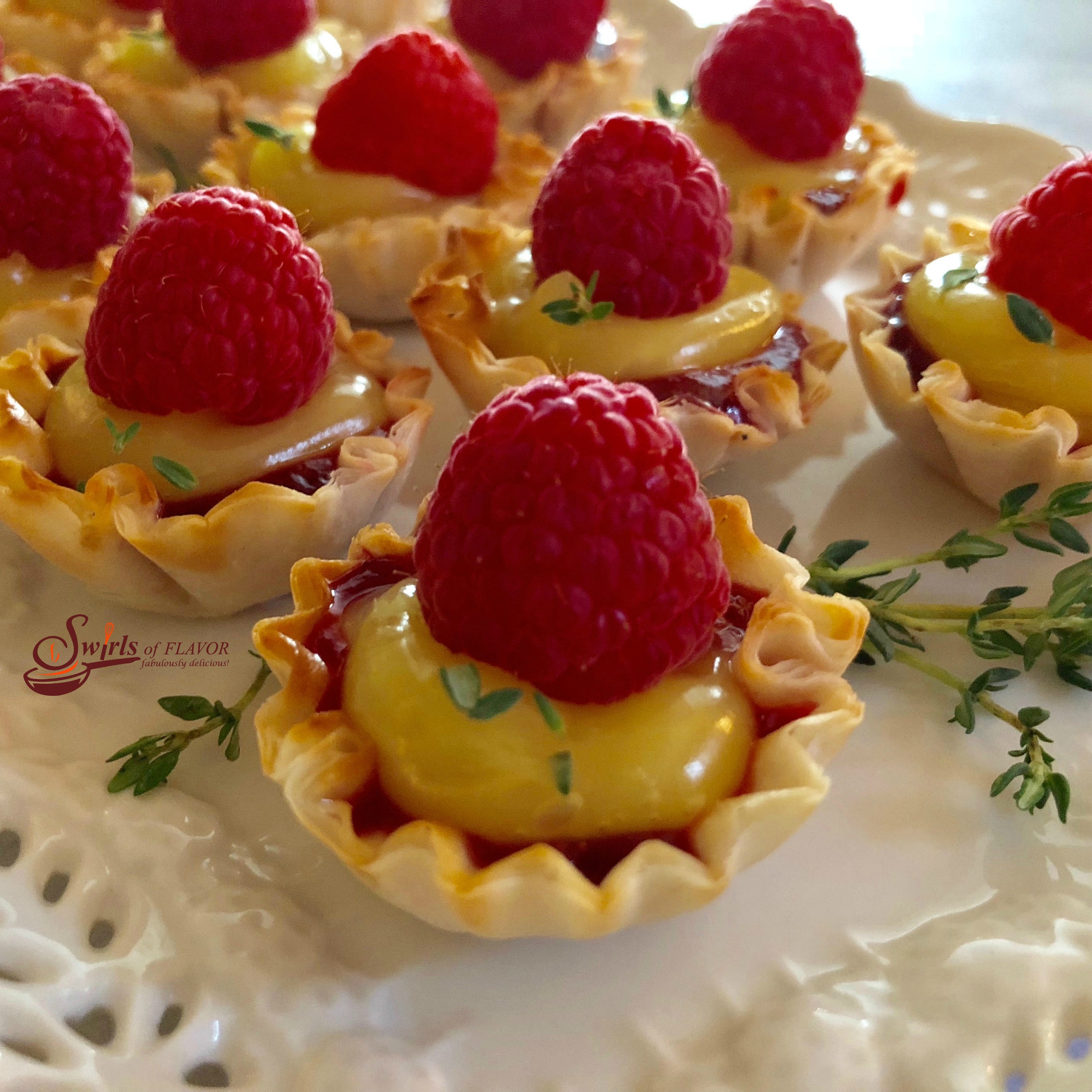 No-Bake Raspberry Lemon Thyme Tartlets are a 5 ingredient quick and easy dessert that's bursting with spring flavors and fruity sweetness! lemon | raspberry | thyme | fillo shells | mini dessert | no bake | no cooking | fresh herbs | easy recipe | #swirlsofflavor