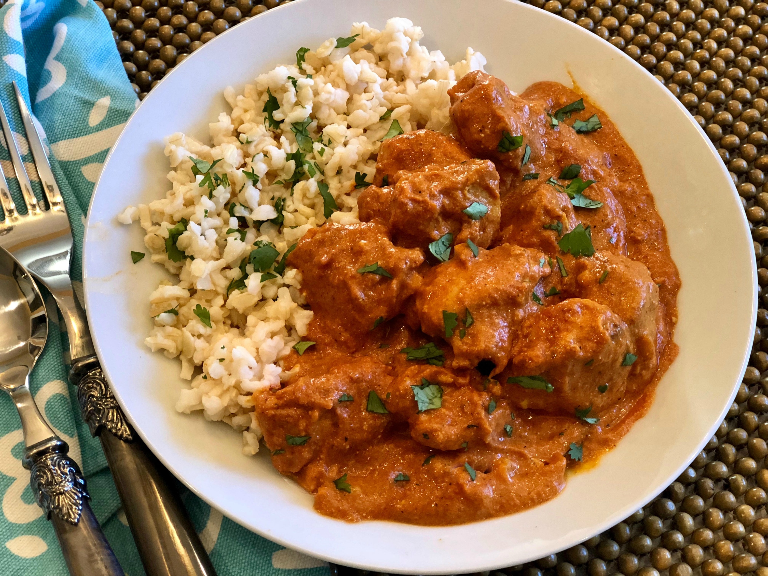 Indian Butter Chicken with rice in a bowl