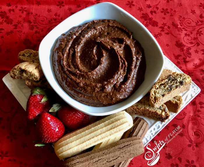 Nutella Hummus combines chickpeas, cocoa powder and hazelnut spread for a protein packed sweet dessert dip that's easy to make and a perfect healthy sweet treat for your next dessert. recipe | easy | dessert | hazelnut | Nutella | hummus | healthy | #swirlsofflavor