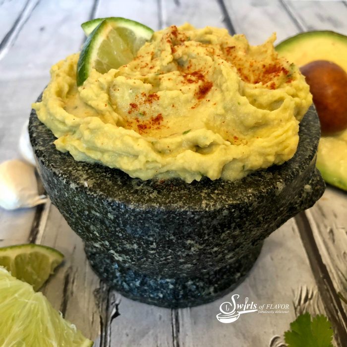 Avocado Hummus is a protein-packed powerhouse of nutritious deliciousness! Traditional chickpeas of hummus team up with the creamy richness of avocado in this easy appetizer recipe. Add a touch of lime, cilantro and, of course garlic, with a hint of chipotle spice and you won't be able to resist dipping in! dip | bean dip | appetizer | easy recipe | chickpeas | appetizer | #swirlsofflavor
